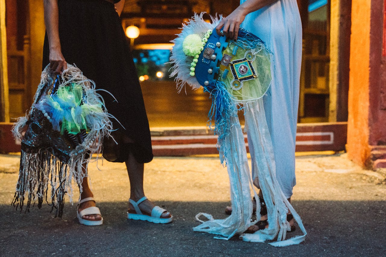 our-experience Women showcasing colorful, feathered costumes during a twilight event in Taiwan.